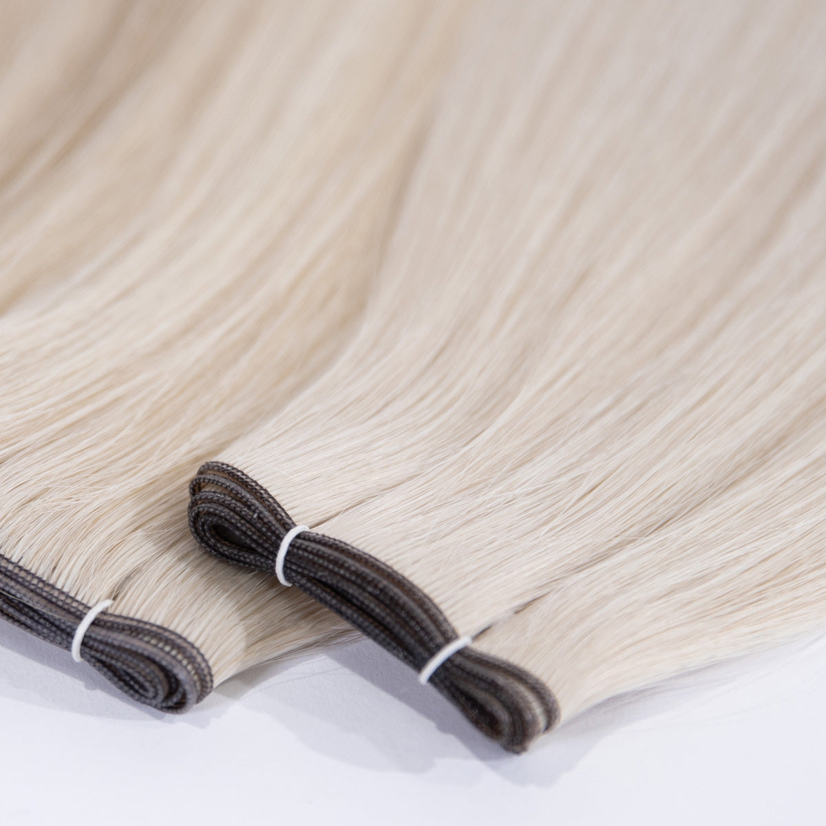 Close-up of the seam and blonde hair on DS HAIR Genius Weft extensions