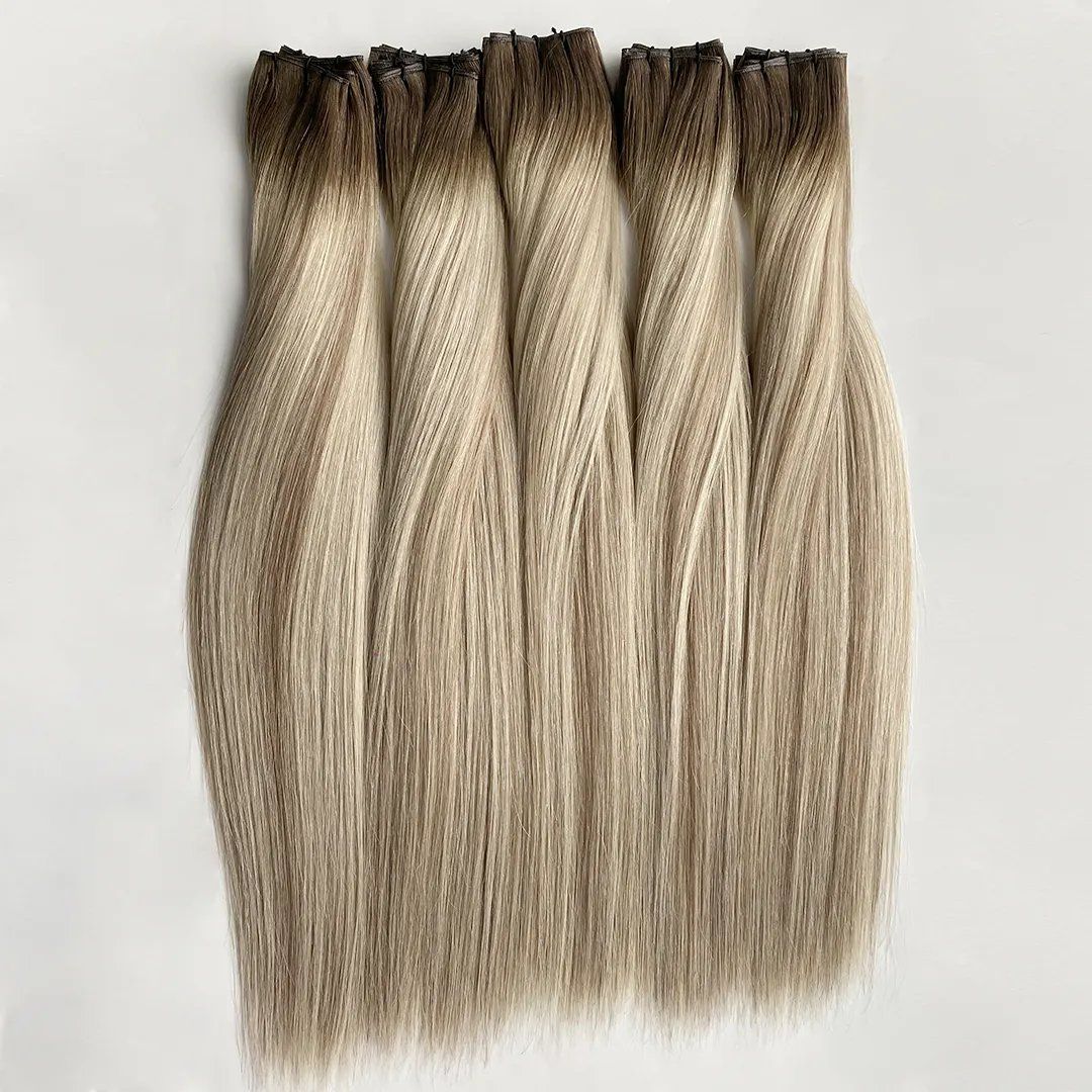 Rooted blonde machine weft extensions in five neat bundles