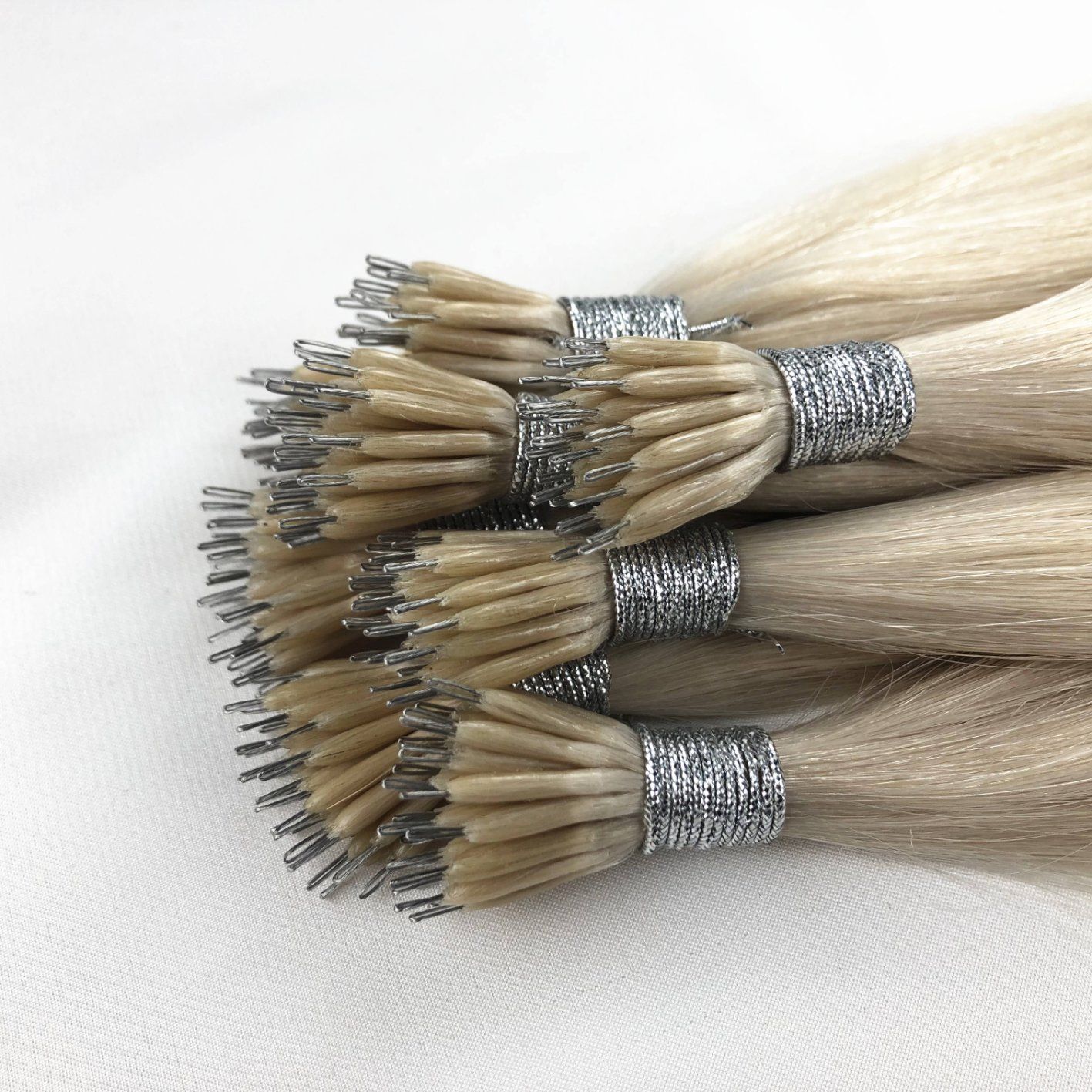 Rooted blonde nano ring extensions in neat rows for colour matching