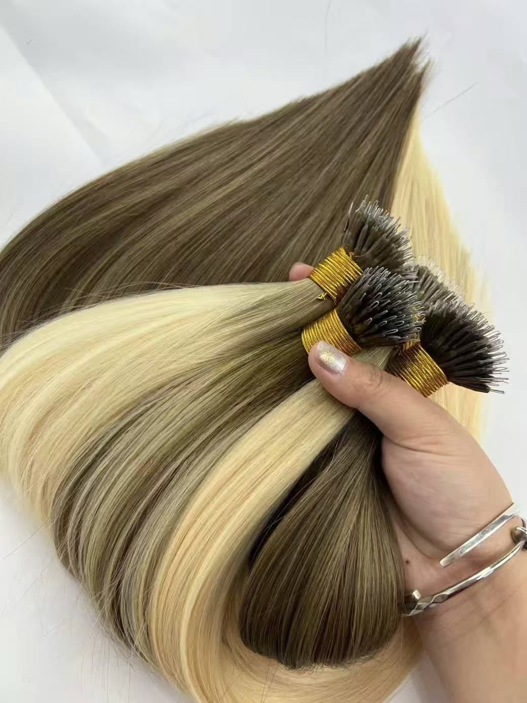 Nano ring human hair extensions laid out with the tiny 0.9mm connector rings