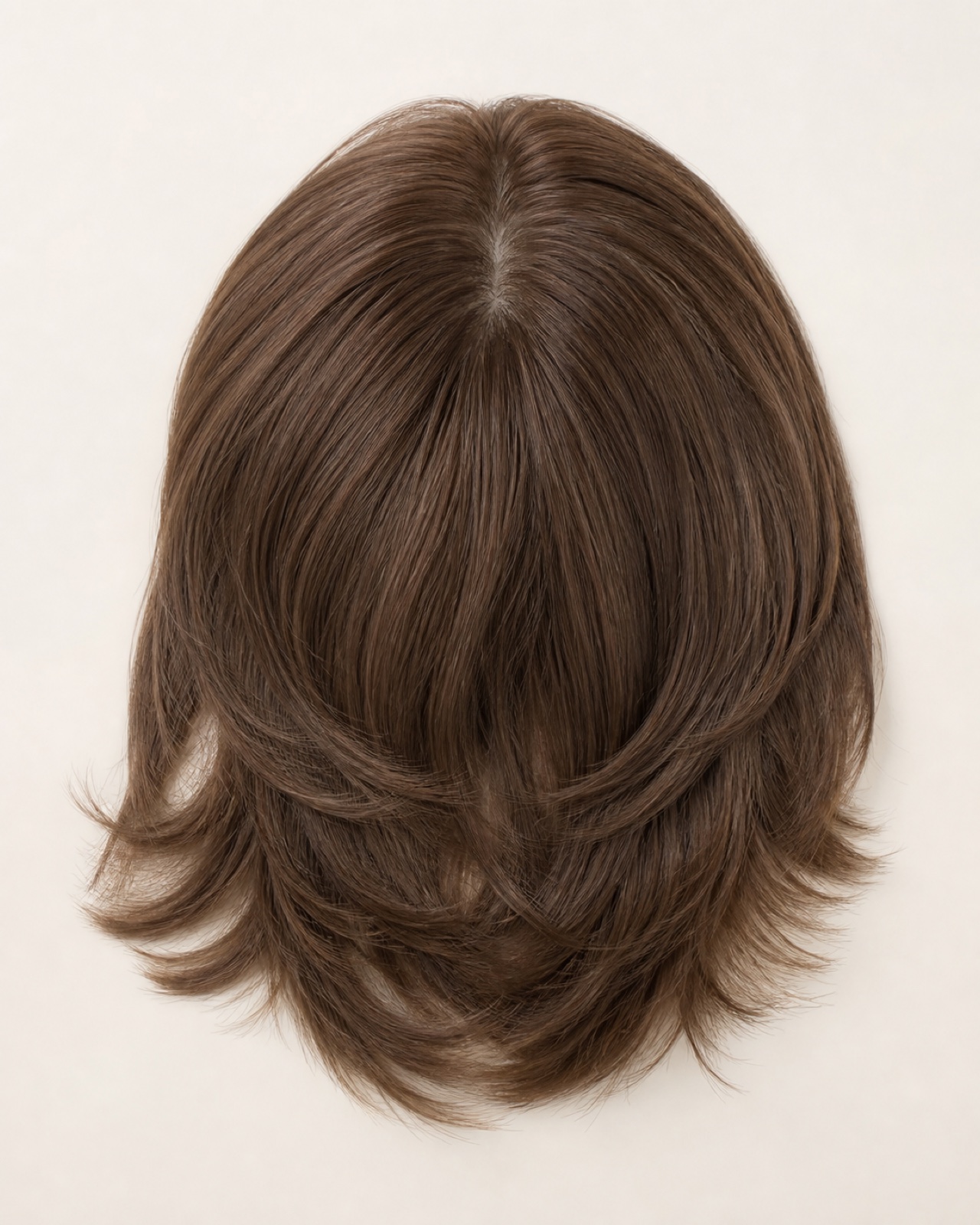 Top view of a medium-brown layered synthetic crown topper concept